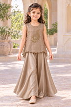 Girl walking in the taupe gold top and satin palazzo set